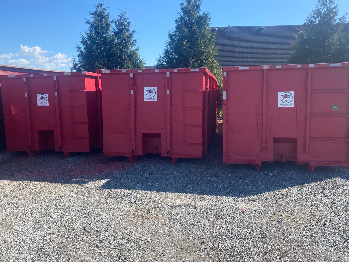 Eric's Disposal bins lined up in the Surrey yard on a bright day